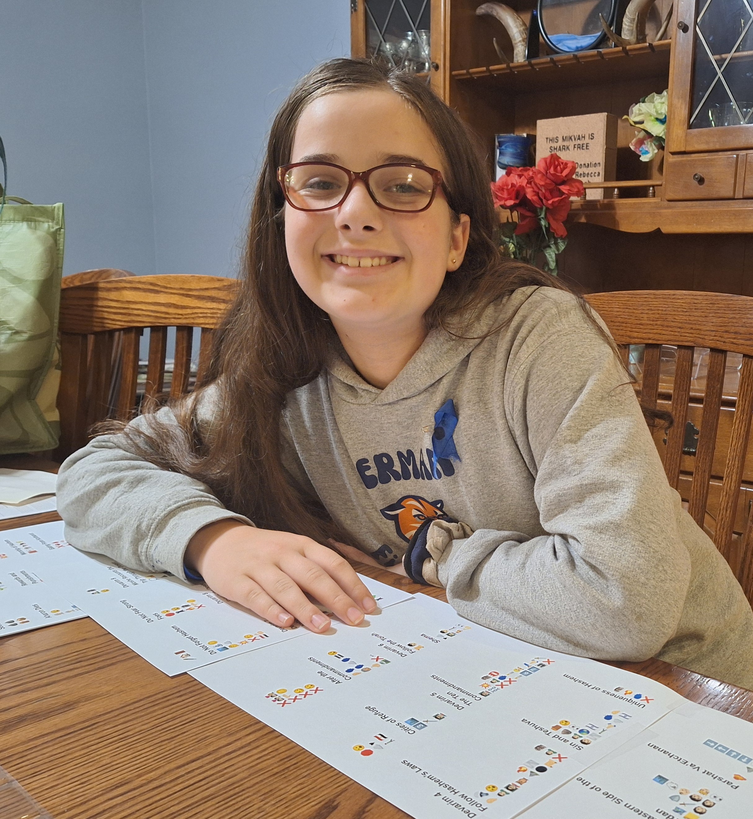 Naomi displaying her printed Emoji Torah scroll